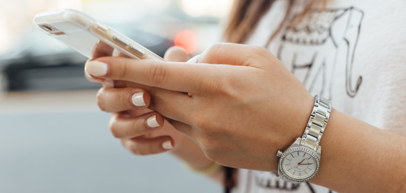 Image of woman looking at her phone