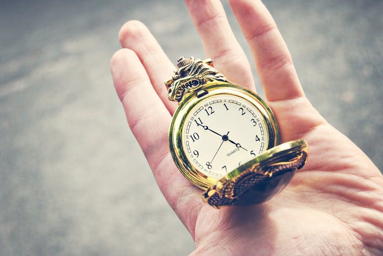 Image of a person holding a clock