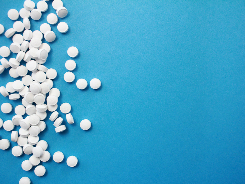 Image of white pills on blue background